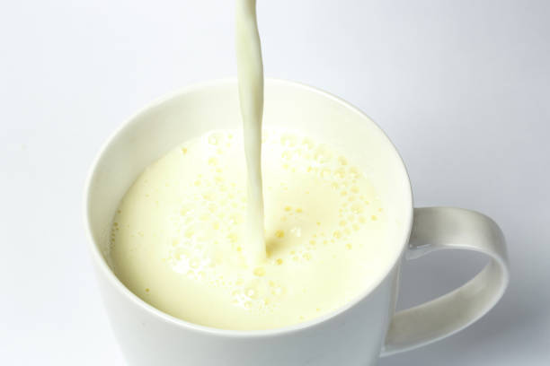 istock Pouring a cup of milk creating splash 1174071506