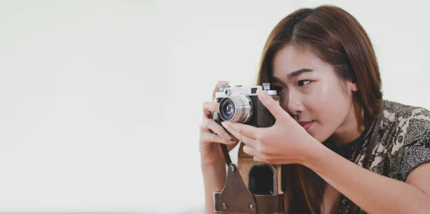 istock Beautiful professional photographer taking a photo with camera 1174071523