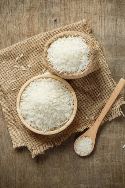 istock Jasmine rice in bowl and sack on wooden table 1174072132