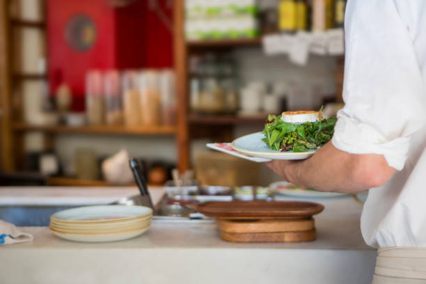 istock Waiter serving food at restaurant 1174073768