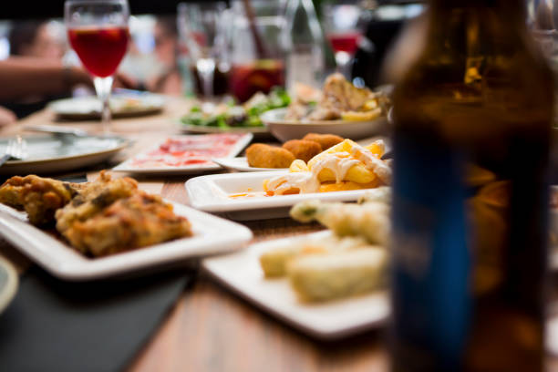 Happy people at the table enjoying various food at the local cafe, selective focus