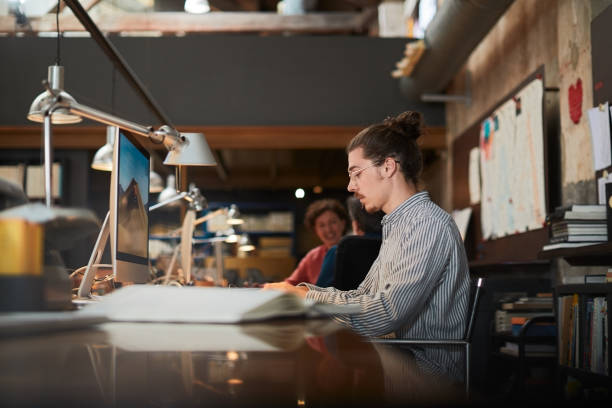 istock Young man focused and working in a business desk designer studio. 1174091848
