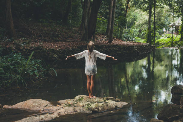 beautiful young woman enjoys in nature - wood tranquil scene serene people lake imagens e fotografias de stock