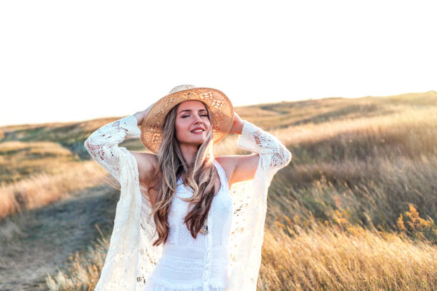 istock Beautiful woman enjoying nature outdoors at sunset. 1174093648