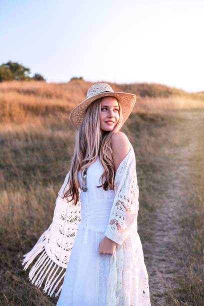 istock Beautiful woman enjoying nature outdoors at sunset. 1174093656