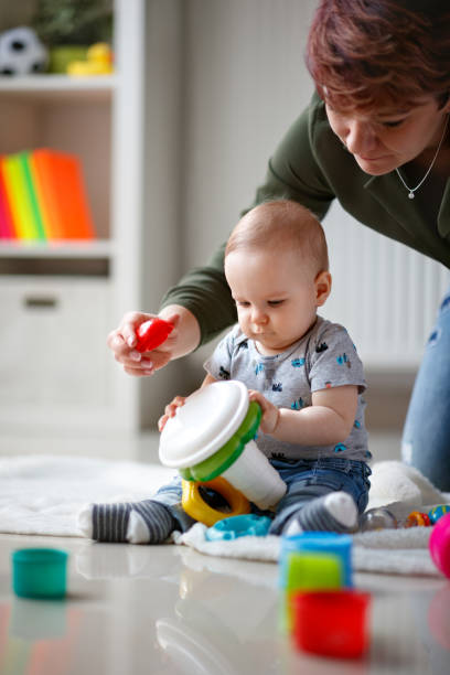 istock Father raises up male baby 1174093751