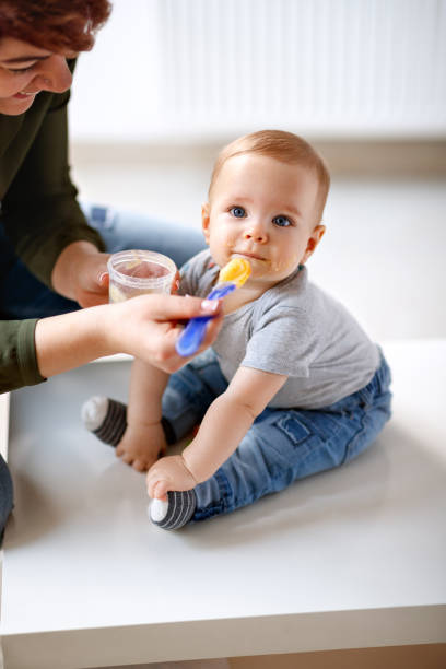 istock Father raises up male baby 1174094229