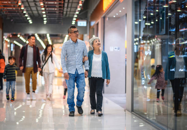 istock Multi-Generation Chinese Shoppers Enjoying Hong Kong Mall 1174098408