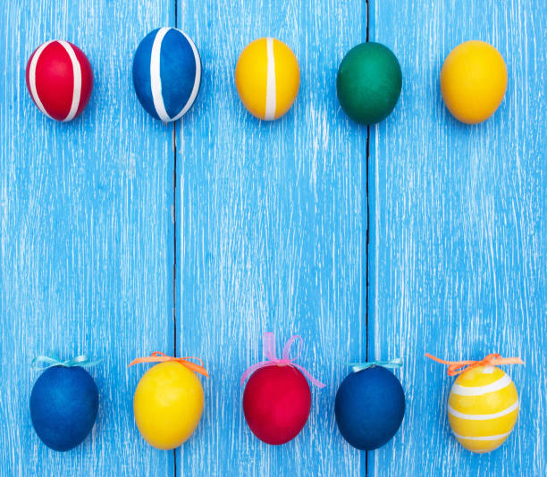 istock Easter colorful eggs on a blue wooden background, copy space, celebration, spring 1174098436