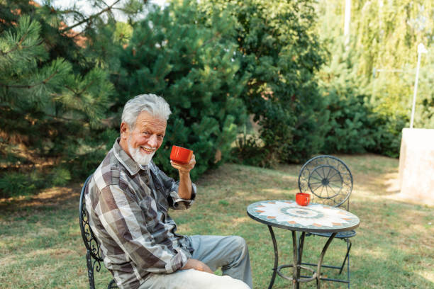 istock Senior Man with Beard Drinking Coffee in his Backyard 1174098548