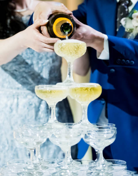 istock Couple pouring champagne in glasses 1174101804