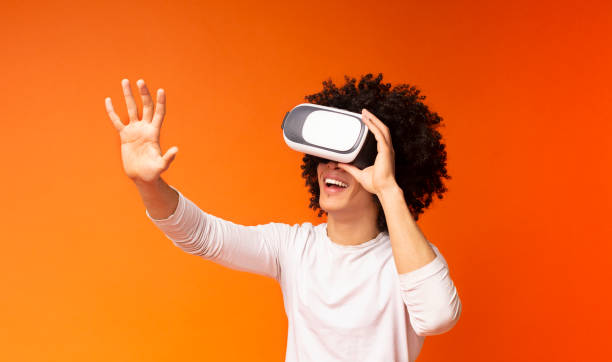 istock Excited black guy pushing virtual button in VR glasses 1174103492