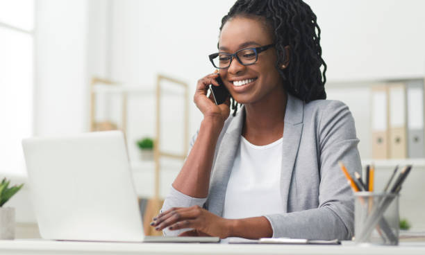 istock Happy Business Girl Having Phone Conversation Using Laptop In Office 1174104023
