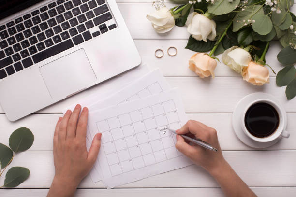 istock Woman choosing the wedding date on workplace with laptop 1174104157