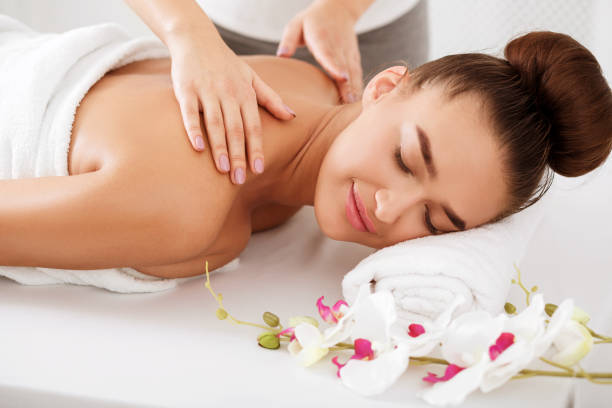 istock Woman enjoying shoulder massage, relaxing with closed eyes 1174106346