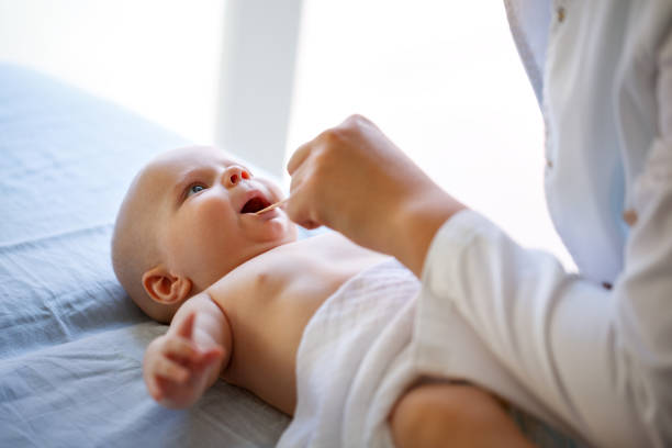 istock Baby wrapped in shawl at pediatric examination 1174109000