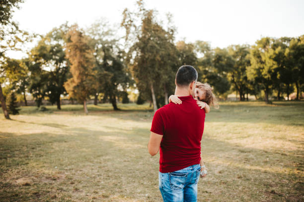 istock Cute girl resting on father's shoulder 1174109953