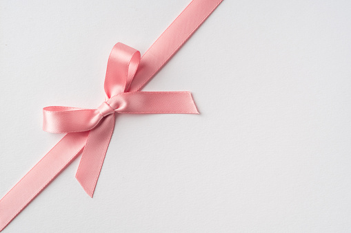 Design concept - top view of pink bow isolated on white background for mockup, it's real photo, not 3D render
