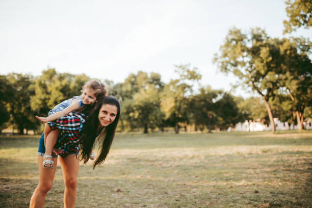 istock Cute girl resting on mother's shoulder 1174109975