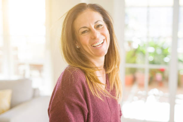 istock Beautiful middle age woman smiling at home 1174110139