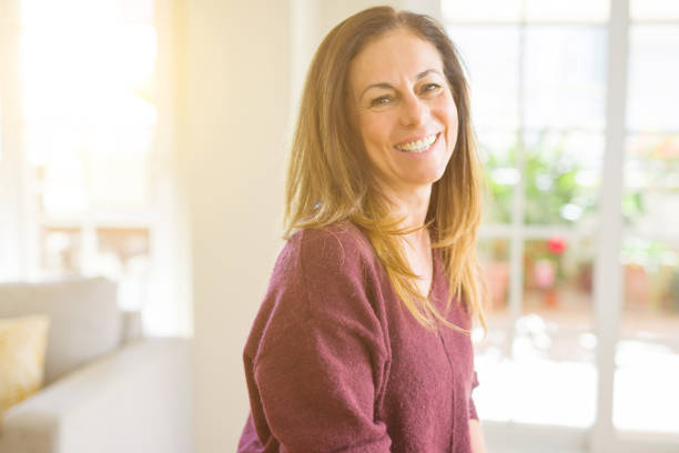 istock Beautiful middle age woman smiling at home 1174110161