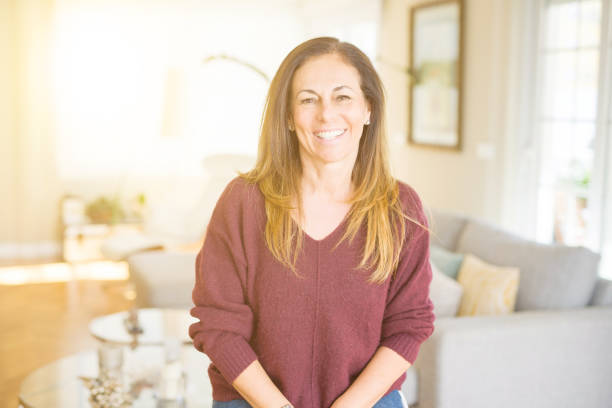 istock Beautiful middle age woman smiling at home 1174110186