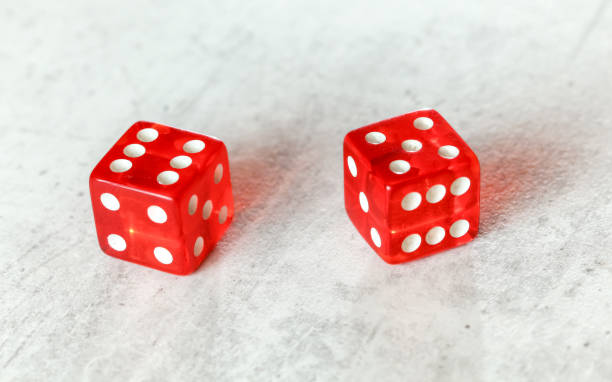 istock Two translucent red craps dices on white board showing Yo (Yo-leven) (number 6 and 5) 1174111424
