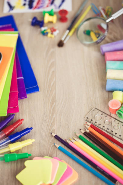 istock School supplies on wooden background 1174111453