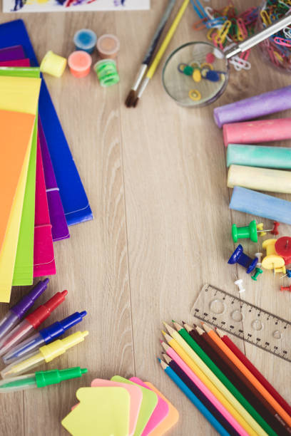 istock School supplies on wooden background 1174111456