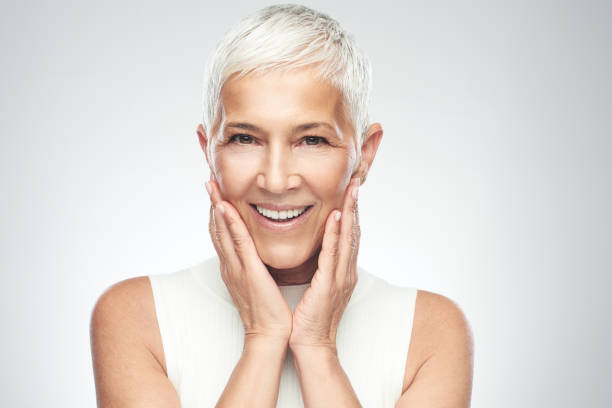 istock Senior woman posing in front of gray background. 1174111995