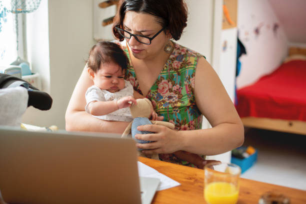 istock Working mom with baby in a lap 1174113673