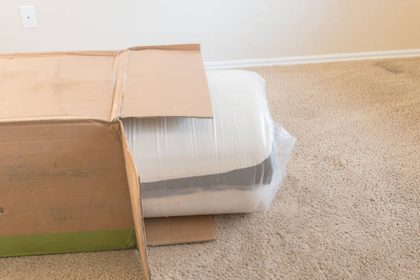 istock Close-up top view roll-packed spring mattresses unbox on carpet floor background 1174113986