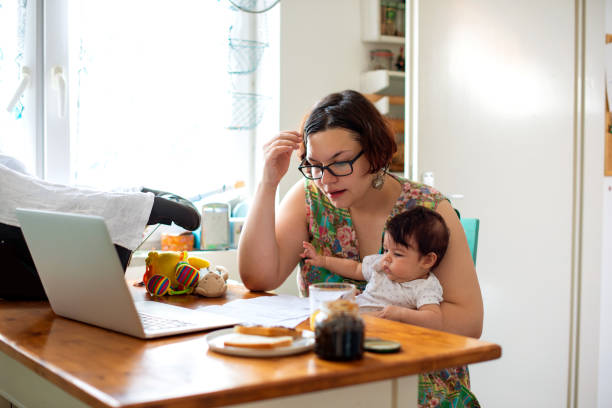 istock Working mom with baby in a lap 1174114020