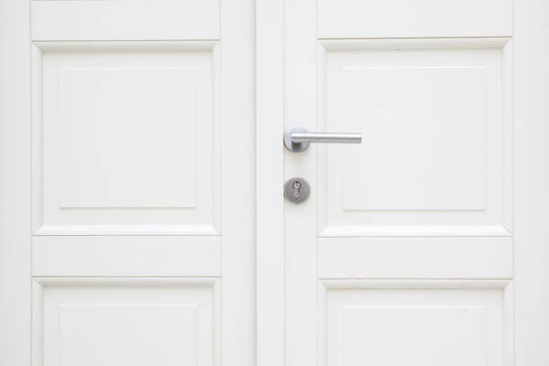 Silver aluminium modern metal handle on a white wooden door