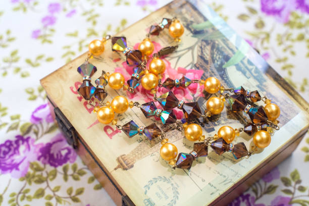 istock Vintage beads crystals and pearls with box and textile background 1174118571