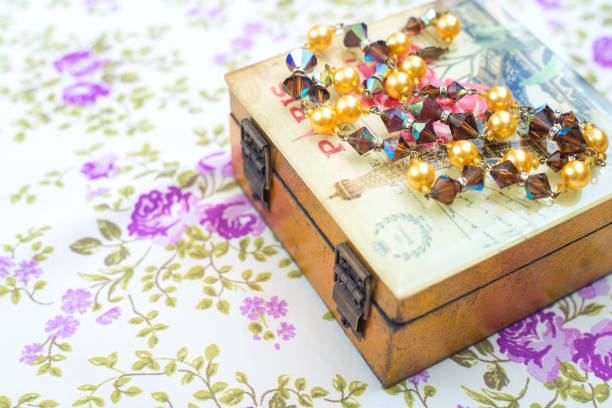 istock Vintage beads crystals and pearls with box and textile background 1174118585