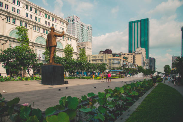 The statue is a tribute to the former president and leader, Ho Chi Minh, which also became the name of this city seen in the picture. Behind the statue the main avenue and commercial buildings can be seen at Saigon Square.