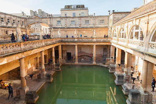 Bath, United Kingdom - November 2, 2017: People are in Roman baths of Bath, Somerset. One of the most popular landmarks of the city