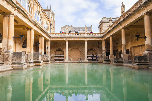 Bath, United Kingdom - November 2, 2017: Tourists are in Roman baths of Bath, Somerset. One of the most popular landmarks of the city