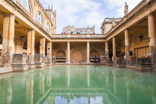 Roman baths of Bath, Somerset. UK Bath, United Kingdom - November 2, 2017: Tourists are in Roman baths of Bath, Somerset. One of the most popular landmarks of the city bath england photos stock pictures, royalty-free photos & images