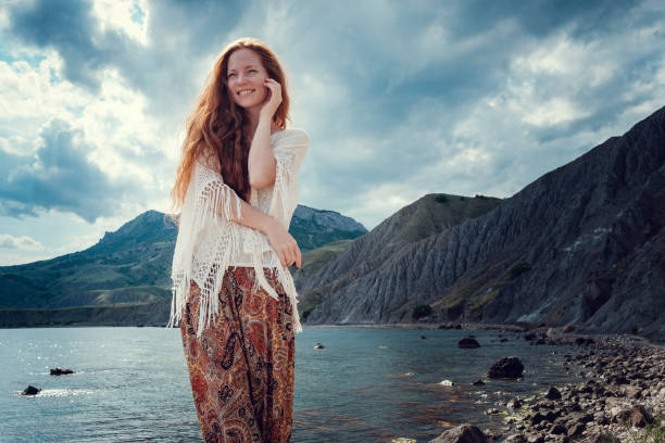 istock Beautiful boho styled model wearing white crochet swimsuit posing on the beach in sunlight 1174125624