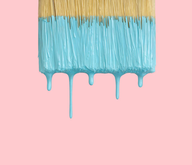 Wet paintbrush closeup on pink with clipping path