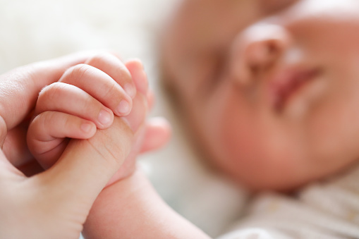 baby hand,Child's hand in mother's hand on pillow,I am Safe Now