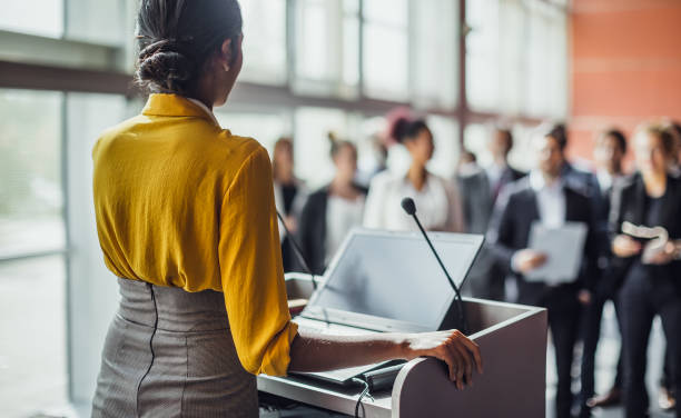 Business People at a Conference Listening to the Speaker Business People at a Conference Listening to the Speaker presenter stock pictures, royalty-free photos & images