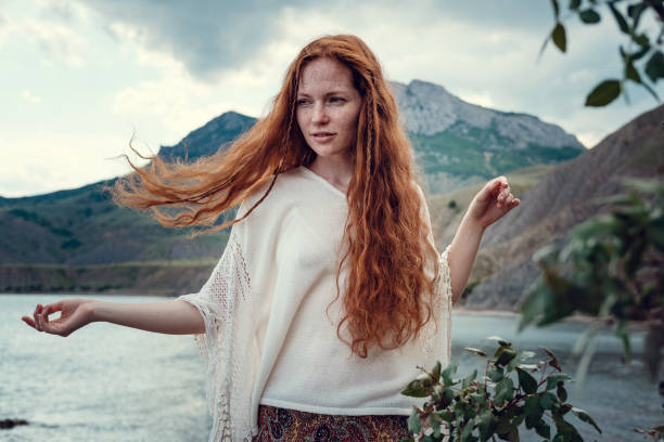 istock Beautiful boho styled model wearing white crochet swimsuit posing on the beach in sunlight 1174128024