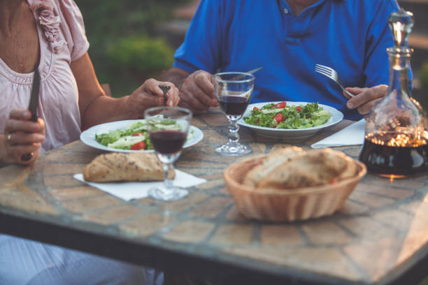 istock Senior couple dinning outdoors 1174128304