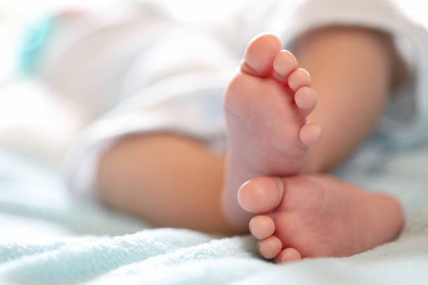 Photo of newborn baby feet A close-up of tiny baby feet foot stock pictures, royalty-free photos & images