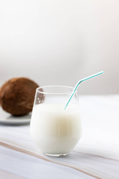 brown coconut with straw, tropical refreshing drink. Coconut milk