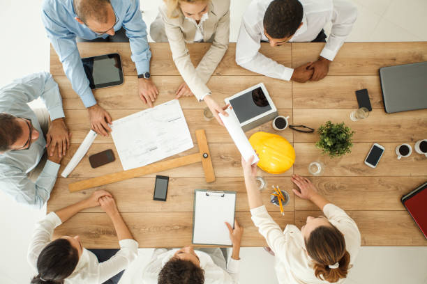 istock Group of architects cooperating on a business meeting 1174131397