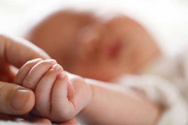 Baby hand in mother hands